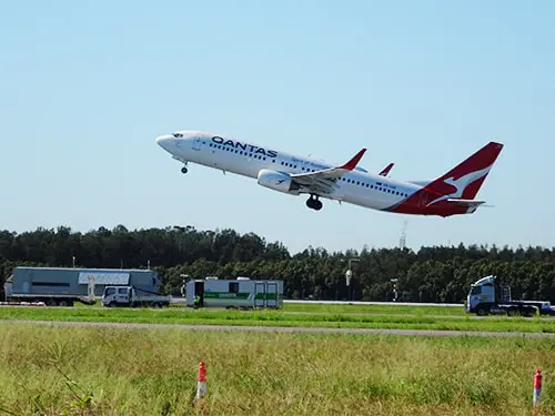 A gunsyn caravan at brisbane airport next to the main runway